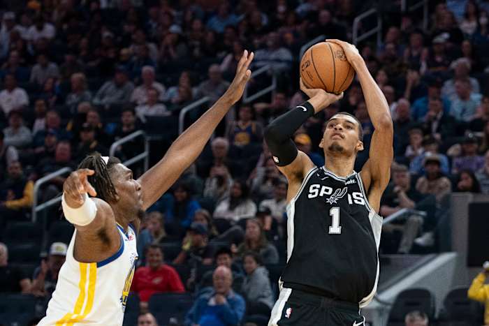 San Antonio Spurs' forward Victor Wembanyama (1) raises up for a jump shot over Golden State Warriors center Kevon Looney